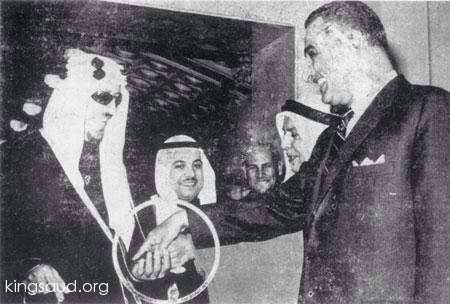 Sheikh Abdullah Al-Salem holds the hands of President Abdel Nasser