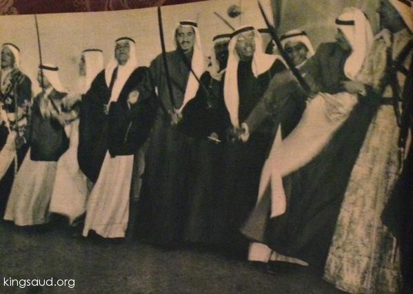 King Saud participates in the Ardha traditional dance, along with King Salman bin Abdulaziz, Prince of Riyadh then، Prince Saad bin Saud and Prince Abdulrahman bin also Saud appear in the photo.