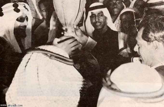 King Saud hands the trophy to Al-Ittihad  goalkeeper Abdullah Hijazi, Prince Thamer bin Saud is seen in the picture which was in Al-Sayegh stadium in Al-Malaz - 1383