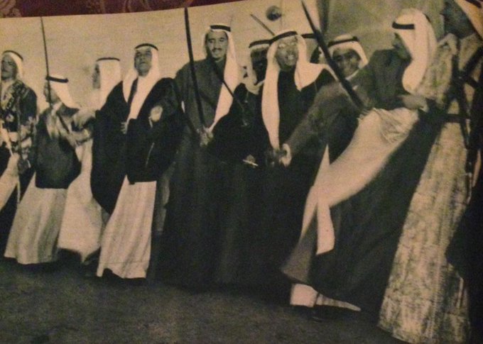 King Saud participates in the Ardha traditional dance, along with King Salman bin Abdulaziz, Prince of Riyadh then.