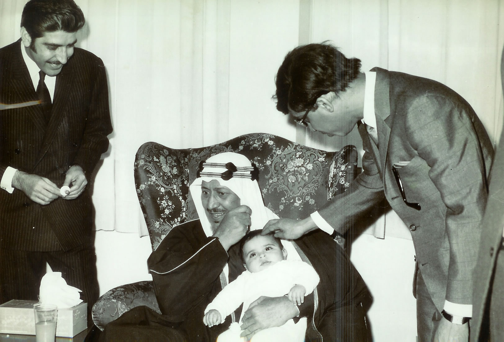 King Saud holding his grand son Abdul Aziz Al- Ghonaim On his right his personal Doctor