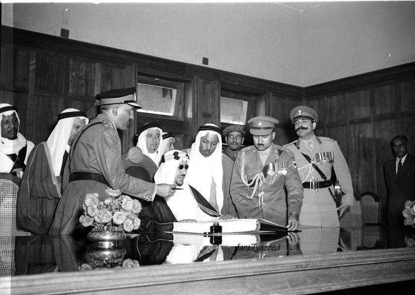December 12, 1955. The visit of King Saud to India. H.M. the King of Saudi Arabia, signing the visitors book on the occasion of his visit to the National Defence Academy, Khadakvasla, near Poona