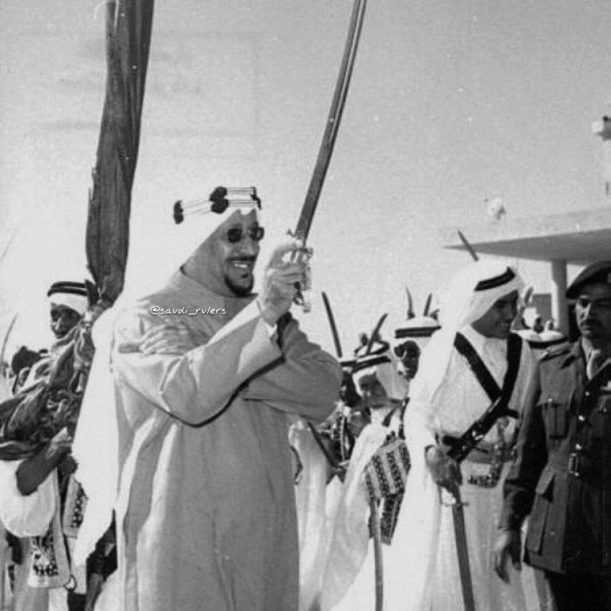 King Saud joinning in the tradtional saudi war dance Al Ardah with his son Prince Khalid in the back