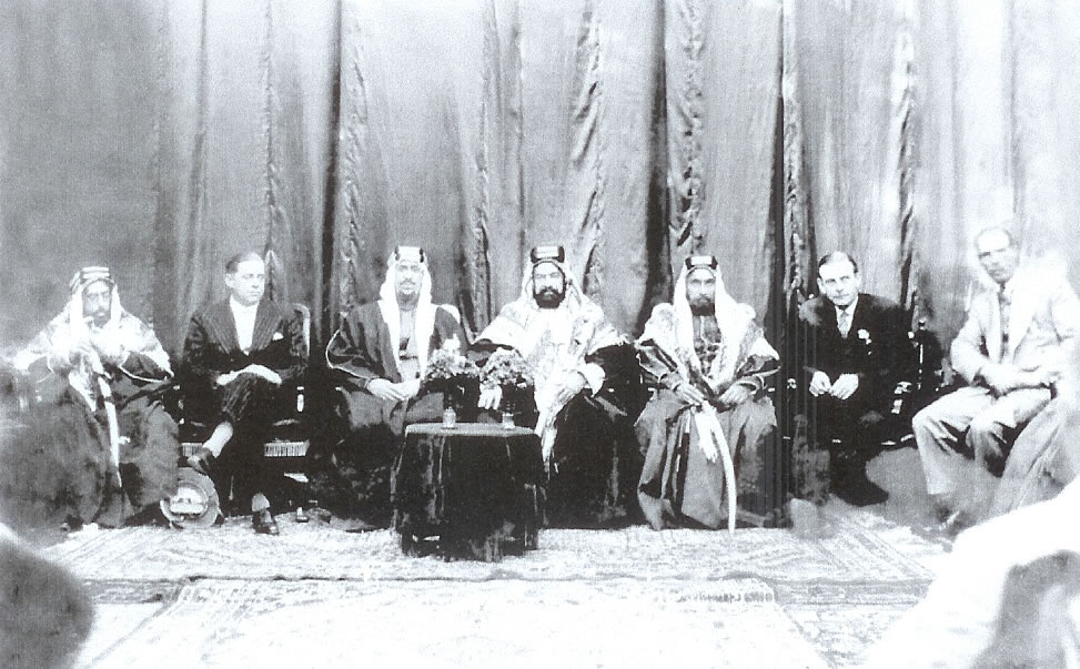 Crown Prince Saud with Shaikh Hamad bin Isa Al-Khalifa, Prince of Bahrain, accompanied by a number of dignitaries during his official visit to Bahrain, Manama, 1356H - 1937