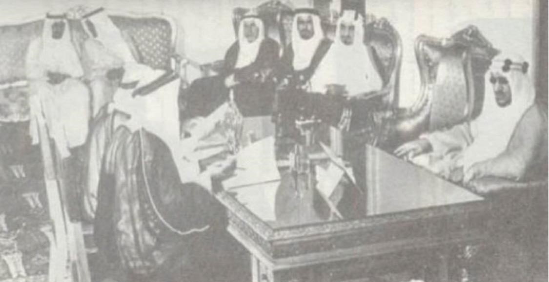 King Saud at the Royal Court with crown prince Faisal Bin Abdalaziz prince Khalid Bin Saud prince Abdul- Illah Bin Saud prince Faisal prince Abdalrahman prince Meshaal and prince Faisal Bin Turki in the background. On the kings right his sons prince Man