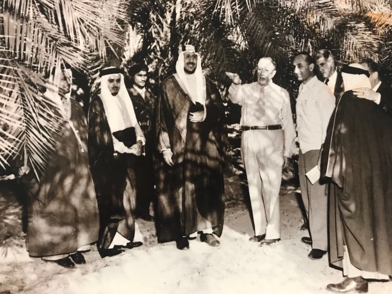 Crown Prince Saud signing his name for children and Mohammed Alireza is seen behind, during the visit to America - 1947