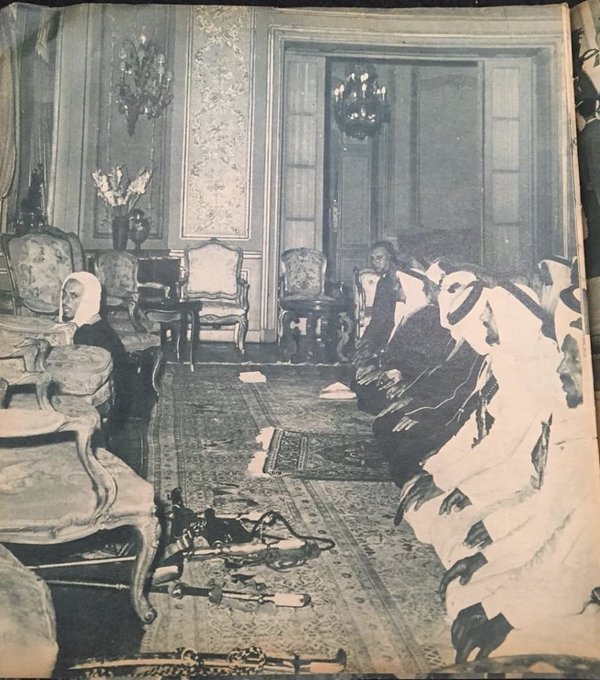 King Saud prays with his entourage at Tahra Palace in Egypt