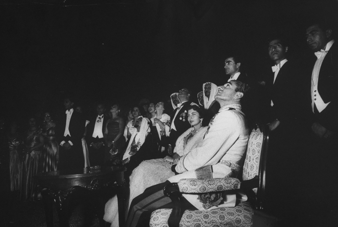 Shah Mohamed Reza (R seated) sitting next to his wife at the garden party honoring King Saud during his visit. (Photo by James WhitmoreTime Life PicturesGetty Images)
