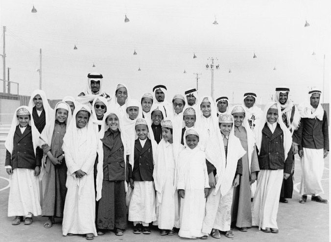 The sons of King Saud — from right to left: Princes Mish‘al, Khalid, Majid, Badr, Thamir, Saad, Faisal, Sultan, and Abdulrahman — during King Saud’s visit to the Eastern Province. The photograph was taken by Ilo Battigelli in Dhahran in 1954.