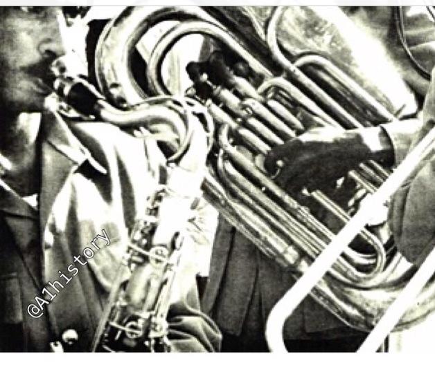 The Royal Anthem band in the Eastern Province performing upon the arrival of King Saud—may God have mercy on him in April 1960.