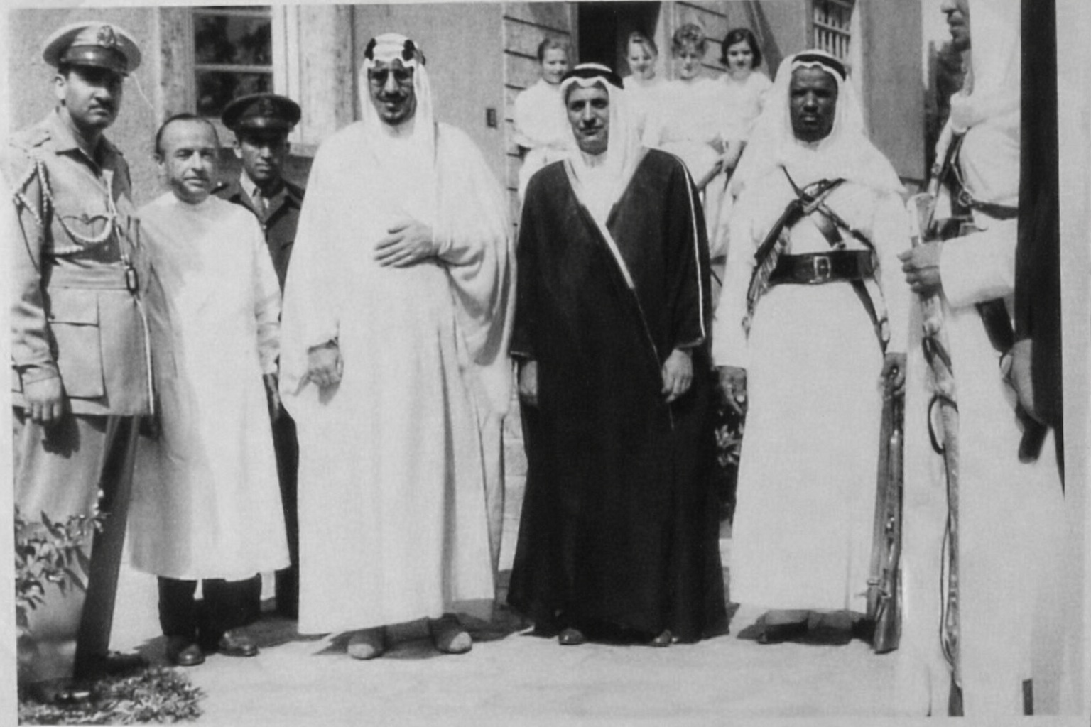 King Saud bin Abdulaziz Al Saud at Freiburg University Hospital in Germany during his visit to his daughter, Princess Nouf, following injuries from fireworks in 1959, with his personal physician Dr. Adeeb Antabi to his left and Major General Abdulmunim Al‑Aqeel to his right.