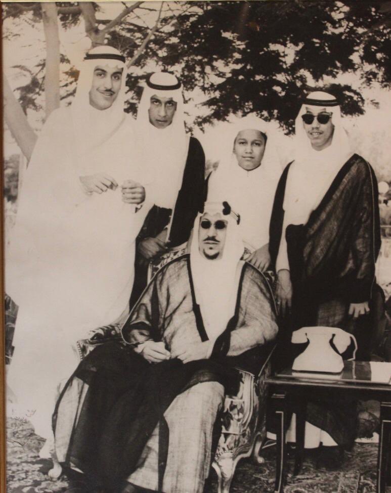 King Saud surrounded by his sons Princes Badr, Abdul‑Ilah, Majid, and Khalid in the garden of Al‑Nasiriyah Palace.