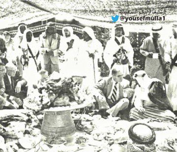 King Saud—may God have mercy on him—attending the celebration held by the Bani Murrah tribe near al‑Ahsa in 1959, accompanied by Prince Saud bin Abdullah bin Jiluwi, Governor of the Eastern Province—may God have mercy on him—and officials from ARAMCO.