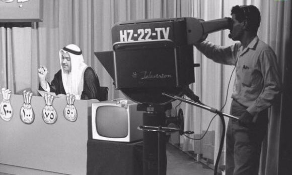 King Saud—may God have mercy on him—together with Fahmi Basrawi during the first television broadcast in Saudi Arabia, transmitted from Dhahran in September 1957.