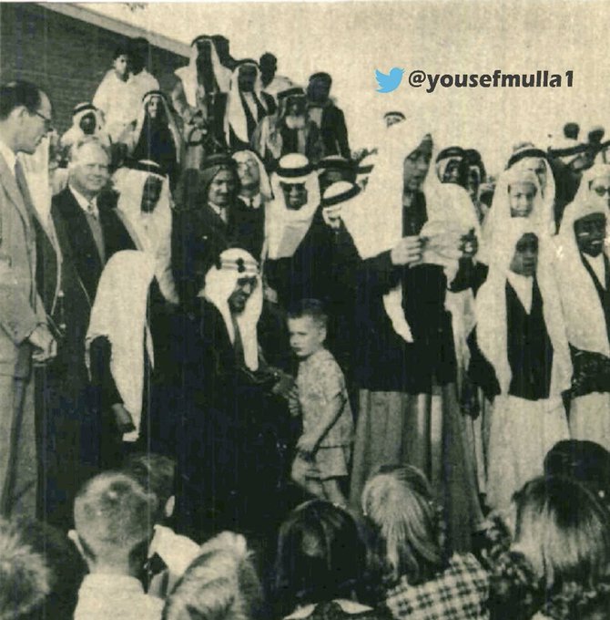 Crown Prince Saud—may God have mercy on him—greeting one of the children of ARAMCO employees in Dhahran in 1953.