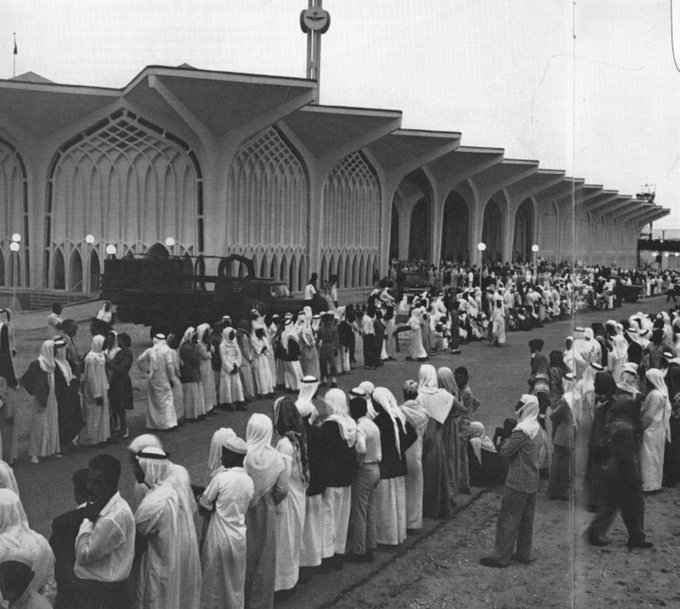Crowds gathering in anticipation of King Saud’s—may God have mercy on him—arrival for the inauguration of Dhahran Airport. King Saud inaugurated Dhahran Airport on 12 Dhu al‑Qi‘dah 1381 AH, corresponding to 16 April 1962.