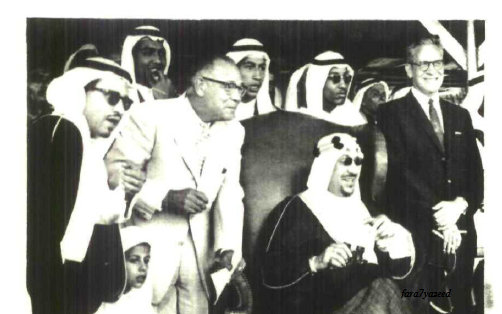 King Saud—may God have mercy on him—watching the fourth horse race in Dhahran, with his sons standing behind him: Prince Thamir, Prince Majid, Prince Sultan, and the youngest, Prince Nawwaf, in 1960.
