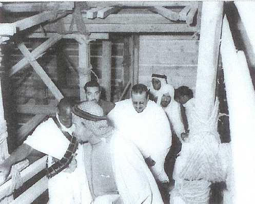 King Saud reviewing the restoration works inside the Holy Kaaba, accompanied by Sheikh Muhammad bin Ladin, in 1374 AH / 1955 CE.
