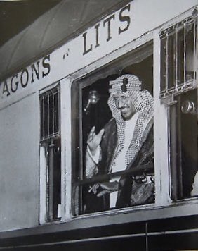 One of the finest photographs of Crown Prince Saud, may God have mercy on him, taken in 1935 at a European train station during his travels between various cities, likely at the Paris train station.