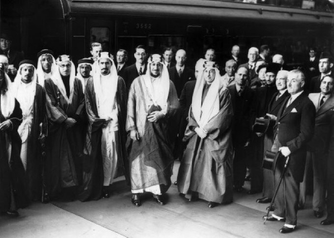 Crown Prince Saud, together with Prince Mohammed bin Abdulaziz and Khayr al‑Din al‑Zarkali, arriving in London with a delegation of fifteen escorts at Victoria Station in 1938.