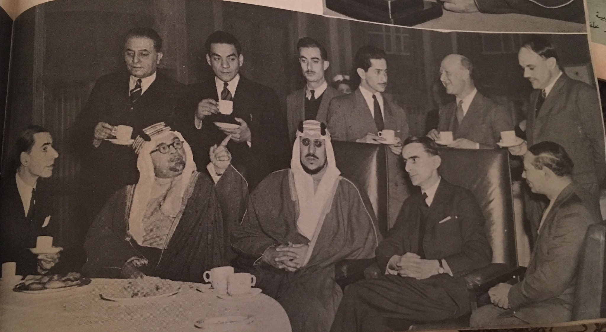 Crown Prince Saud speaking to the British Broadcasting Corporation (BBC) in London, accompanied by Hafiz Wahba, Sayf al‑Islam ʿAbdullah, and Anthony Eden, in 1948.