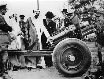 Crown Prince Saud inspecting artillery at the Aldershot Barracks in Britain in 1937, accompanied by Dr. Rif‘at Sheikh al‑Ard and Hafiz Wahba.